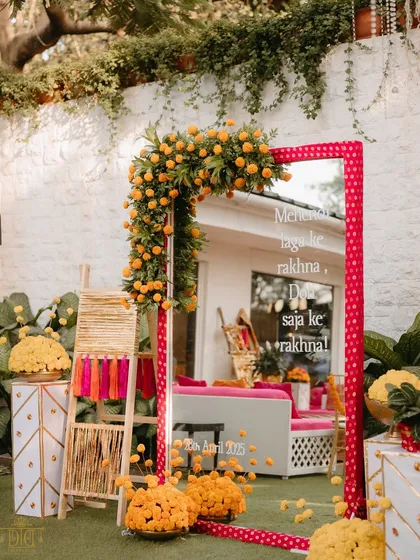 A fun and quirky mirror with the classic line "Mehendi laga ke rakhna" was a hit with guests. Framed in pink polka dots and adorned with marigolds, it was a playful nod to Bollywood wedding culture.