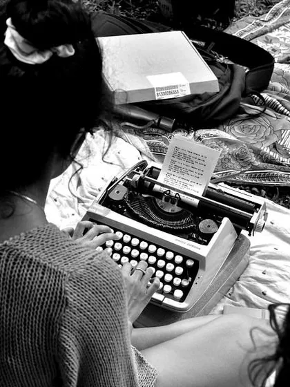 A black and white photo capturing me at work on the typewriter. There's a certain timelessness to the act of typing on this old machine, creating something tangible in a digital world.