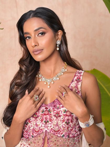 A festive look that feels light yet luxe. This makeup on a dusky beauty features a glowing base, understated glam on the eyes, and radiant highlights.