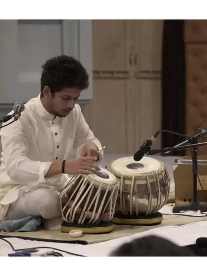 Tuning the tabla before a performance. This process is crucial for achieving the perfect pitch and tone, ensuring the instrument sings with clarity.
