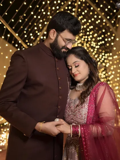 For evening events like receptions or engagements, I use lighting to create a warm and intimate atmosphere. This portrait captures a quiet moment between the couple against a backdrop of fairy lights.