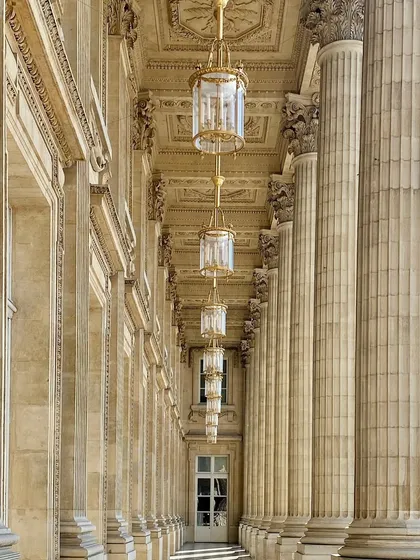 Walking through Paris, I am always inspired by the perfect symmetry and intricate details of its architecture. This colonnade, with its grand chandeliers and ornate ceilings, feels absolutely timeless. These beautiful lights are from the masters at Mathieu Lustrerie.