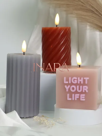 A closer look at some of our new pillar candle designs, including a ribbed texture, a spiral shape, and one with the message 'Light Your Life'.