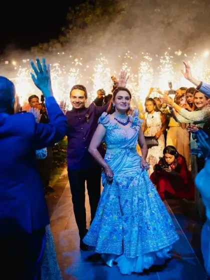 The couple makes a sparkling entrance to their welcome dinner, greeted by enthusiastic guests. I use elements like cold pyros to make every entrance feel special and celebratory.