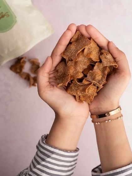 A handful of my Nachni Chips, made with ragi and cumin seeds. This image emphasizes the pure, crunchy goodness you can feel good about.