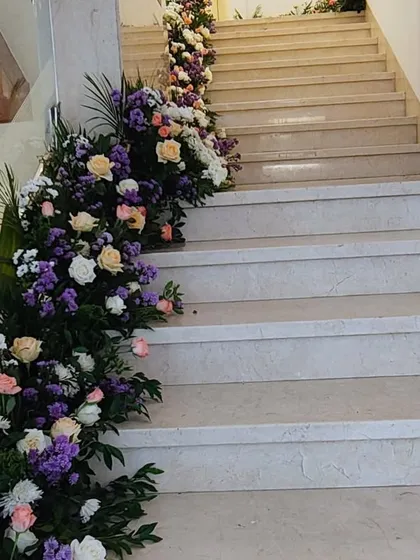 We can transform simple spaces like staircases into beautiful photo opportunities with cascading floral arrangements.