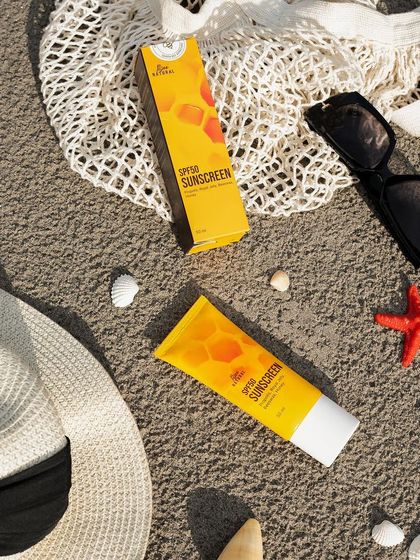 A classic beach-themed flat lay for a sunscreen product. Complete with a sun hat, sunglasses, and seashells, this shot instantly evokes a feeling of a sunny day by the sea.