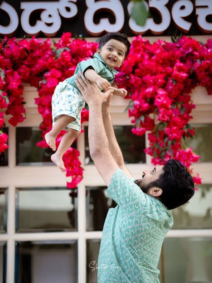 A candid moment of pure joy as a father lifts his son into the air. This outdoor family session captures the fun and love between them.