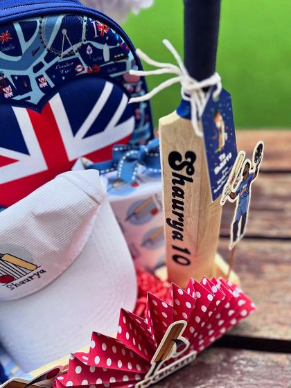 Close-up on the personalized mini bat with the child's name and age, a keepsake from his special day.