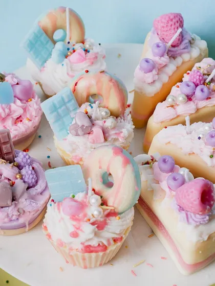 This platter showcases the variety in my dessert candle collection. You can see intricately decorated cupcakes with donut toppers and cake slices with berry and chocolate details. Each one is a small piece of art, handcrafted with precision.