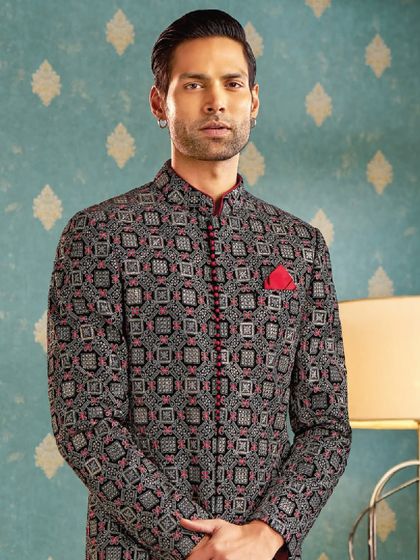 Bold patterns meet timeless charm in this black and red geometric print bandhgala. The red piping adds a sharp, defined edge to this statement piece.