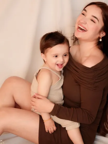 A burst of shared laughter between mother and son. This image is pure happiness, perfectly capturing a moment of unguarded, infectious joy.