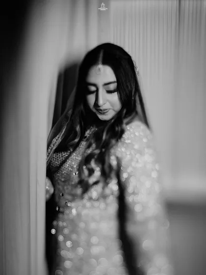 A black and white portrait of a Muslim bride, capturing her elegant and pensive mood.