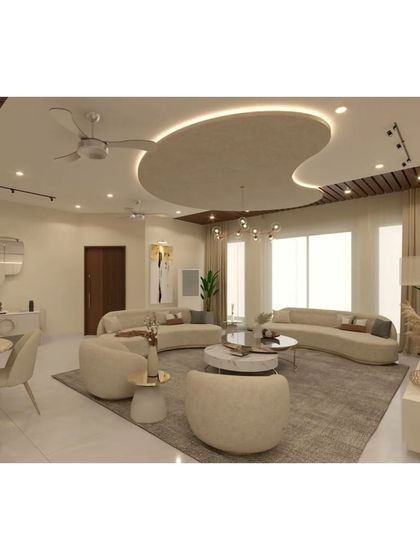 A wider view of the open-plan living and dining area, showing the cohesive design language. The combination of wood-paneled ceilings and soft, modern furniture creates a warm and contemporary feel.