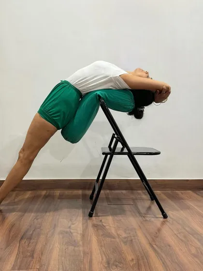 A chair and bolster combination for Purvottanasana. This setup is particularly beneficial for opening the shoulders and chest while providing gentle support for the head and neck.