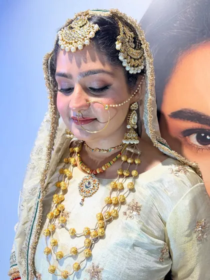 A portrait of our bride showcasing her complete look. The makeup is balanced to enhance her features without overpowering them, perfect for traditional ceremonies and photographs.