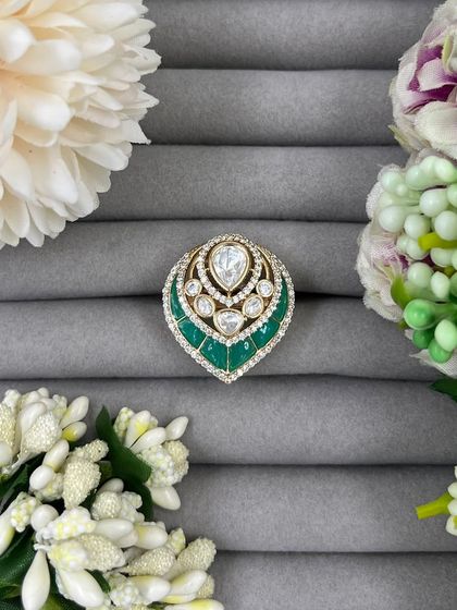 Our leaf-shaped adjustable rings, featuring a large central Moissanite stone surrounded by American Diamonds. These are available in green, red, and pink Meenakari finishes.