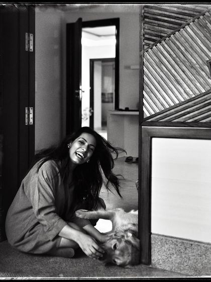 Shivika, sharing a playful moment with her dog on the floor. The low angle and her laughter make this feel incredibly intimate and real.