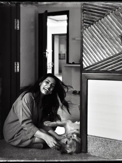 Shivika, sharing a playful moment with her dog on the floor. The low angle and her laughter make this feel incredibly intimate and real.