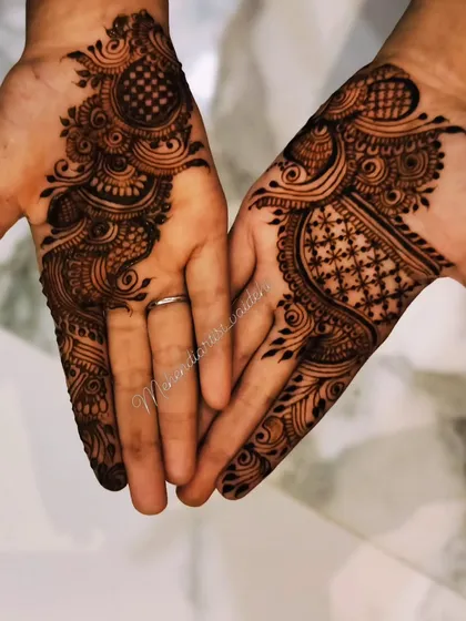 A beautiful Arabic belt design that creates a 'V' shape on the palms. The mix of swirls, dots, and checkerboard filling gives it a lot of texture and interest.
