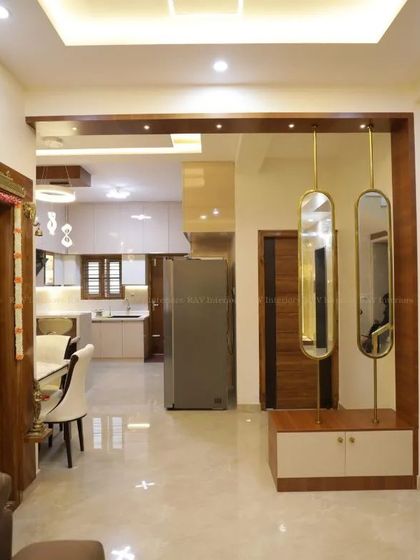 An open-plan layout where the foyer, with its elegant mirror and console, flows seamlessly into the dining and kitchen areas.