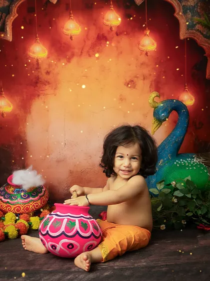 A heart-melting smile from the toddler in his Krishna attire.