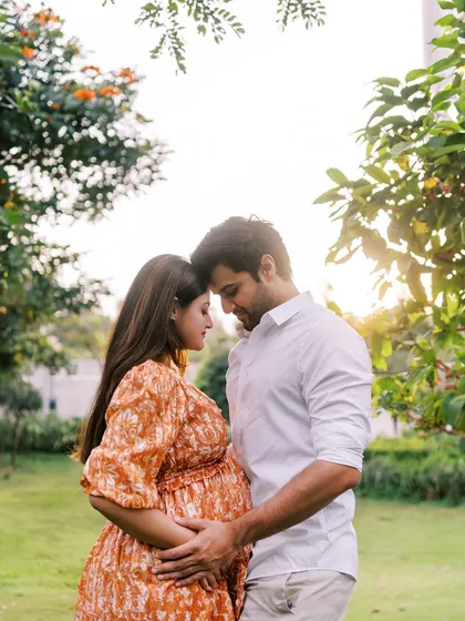 A beautiful silhouette of the couple against the setting sun. This classic pose, with their foreheads touching, is a powerful symbol of their unity and shared dream.