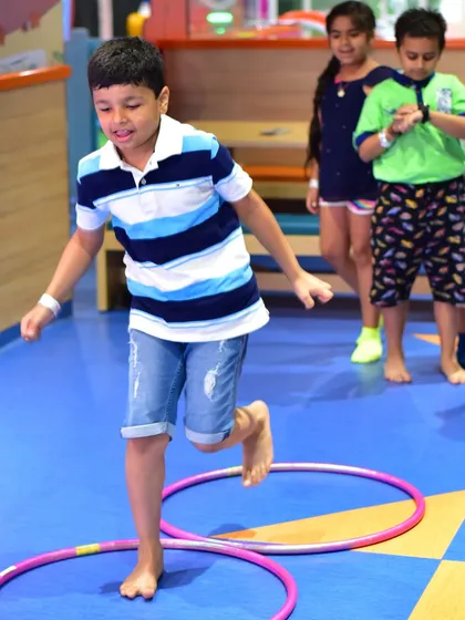 A boy participates in a hula hoop agility game during our summer camp.