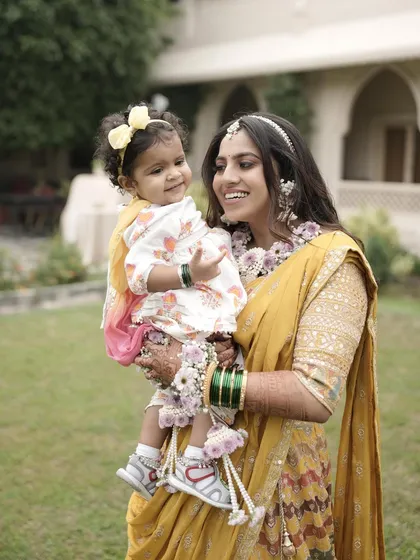 A beautiful moment between a mother and her baby, both adorned with our delicate floral accessories.