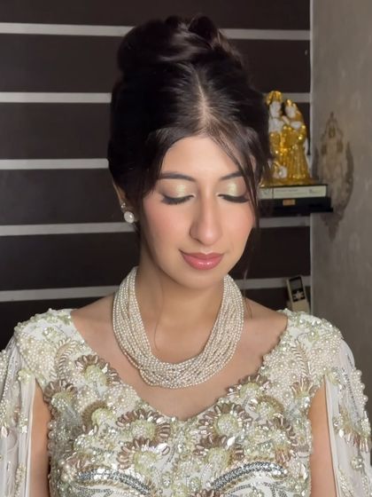 An elegant updo paired with a shimmery gold eye. This close-up shows how the hair and makeup work together to create a classic and timeless look.
