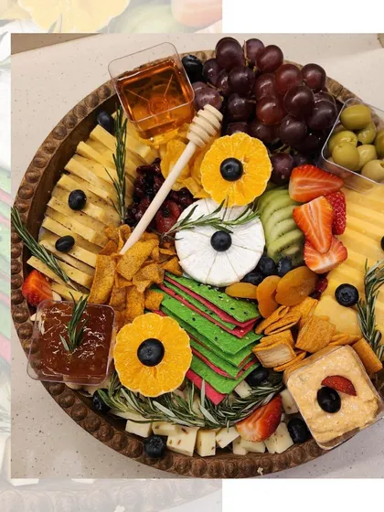 A beautiful cheese and fruit platter, showcasing a variety of textures and flavors. We pair different cheeses with complementary fruits, crackers, and jams to create a perfectly balanced board.