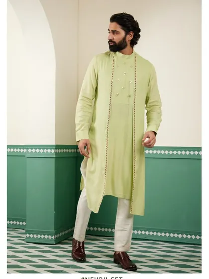 Another view of the light green kurta, showing its flow and modern cut.