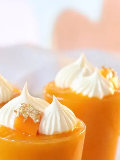 A close-up of the Aamras Shot, showing the delicate meringue kiss and gold leaf detail.