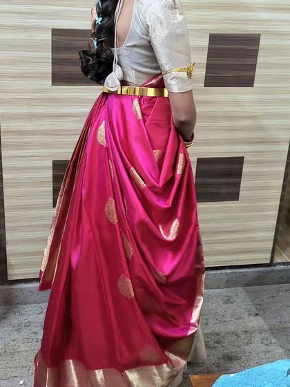 The back view of a can-can or butterfly draping. This style adds significant volume and a dramatic flair, transforming a saree into a grand outfit.