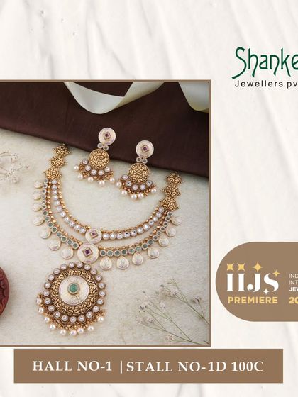 A touch of vintage grace is evident in this layered necklace set. The design uses coin-like elements and a central Kundan pendant, creating a beautiful fusion of styles.