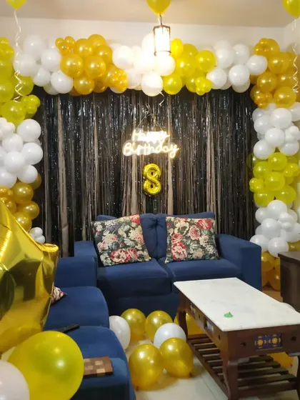 Another angle of the yellow and white 8th birthday home decoration.