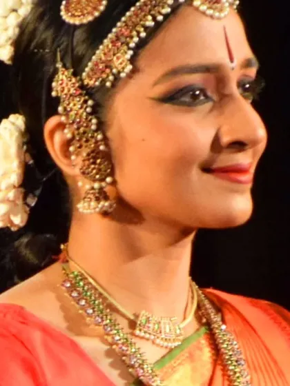 A profile shot from a performance, highlighting the intricate temple jewelry and makeup, known as Aharya Abhinaya, which is crucial for transforming into a character on stage.