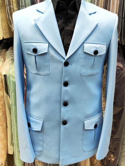 More examples of our unique tailored pieces, including different colors and styles of safari suits and blazers for clients seeking a distinctive wardrobe.