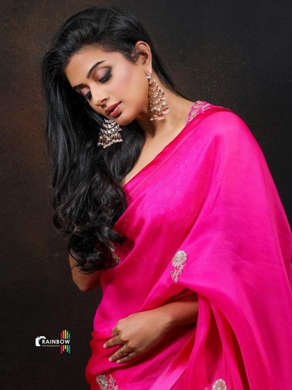 A pensive portrait of Priyamani, showcasing the beautiful earrings and the soft texture of the saree.