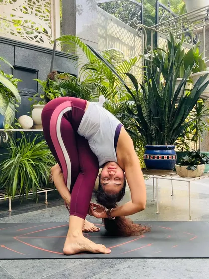 Baddha Uttanasana, or Bound Forward Fold, is a deep stretch for the hamstrings and shoulders. It teaches us that true strength is being strong enough to be gentle with ourselves.