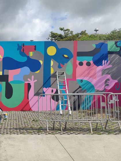 A work-in-progress shot of a colorful abstract mural for the Reunion Graffiti Festival.