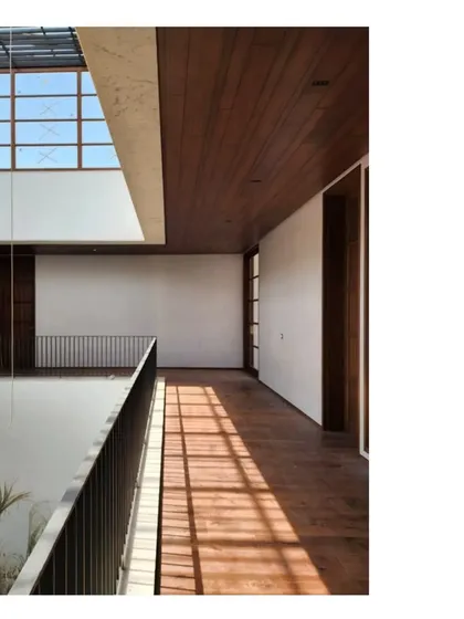 Sunlight streams across a wooden bridge in our Ishtika project in Dubai. The warmth of the wood contrasts with the cool, sand-toned brick, creating a rich sensory experience.