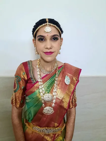 A full-length view of the bride's Varapooja look. The makeup is designed to be picture-perfect from every angle, ensuring she looks radiant throughout the ceremony.