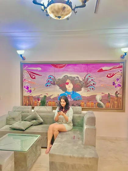 A happy client in her happy home. Seeing my art become part of someone's daily life is the most rewarding part of what I do. This large custom painting was designed to fit the scale and energy of her living room.