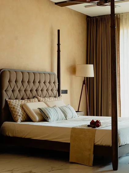 A bedroom should be a personal sanctuary. This custom four-poster bed, crafted from rich, dark wood with an elegant tufted headboard, serves as the centerpiece for a truly luxurious and restful retreat.