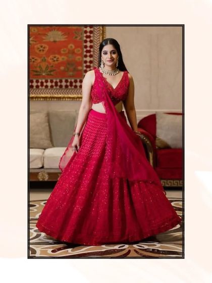 A full-length shot of the red chikankari lehenga, showing its beautiful flare and elegant design.