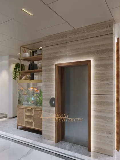 Another angle of the elevator lobby, highlighting the warm, backlit stone paneling and the seamless integration of the fish tank.