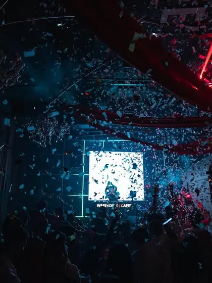 A storm of confetti and lasers over the crowd at Warehouse Cafe, Nagpur.