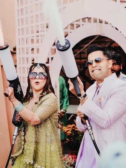 A fun-loving couple makes a grand entrance at their Mehendi with CO2 jets, showing how I incorporate high-energy, modern elements into traditional functions.