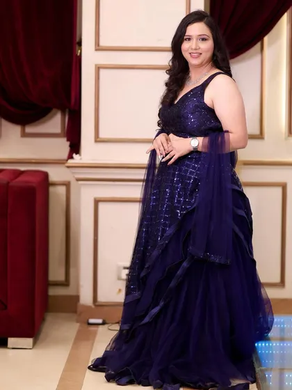 The full view of this elegant party outfit. The makeup is designed to complement the rich color of the gown.